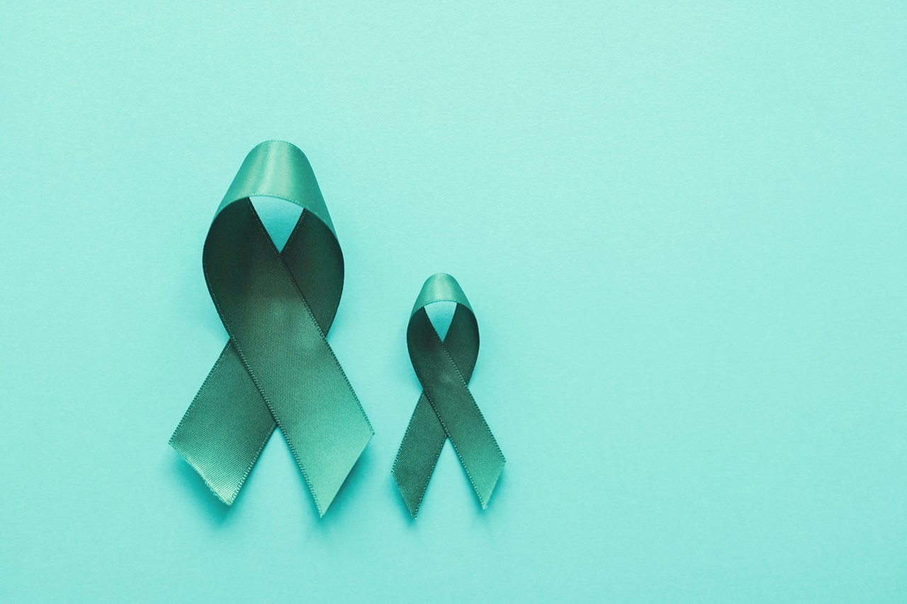 Teal ribbons on top of a teal background as a symbol of the fight against ovarian cancer