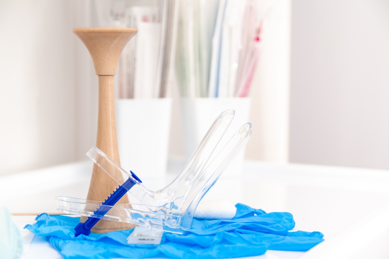 Medical instruments laid out on a table vaginal speculum, gloves