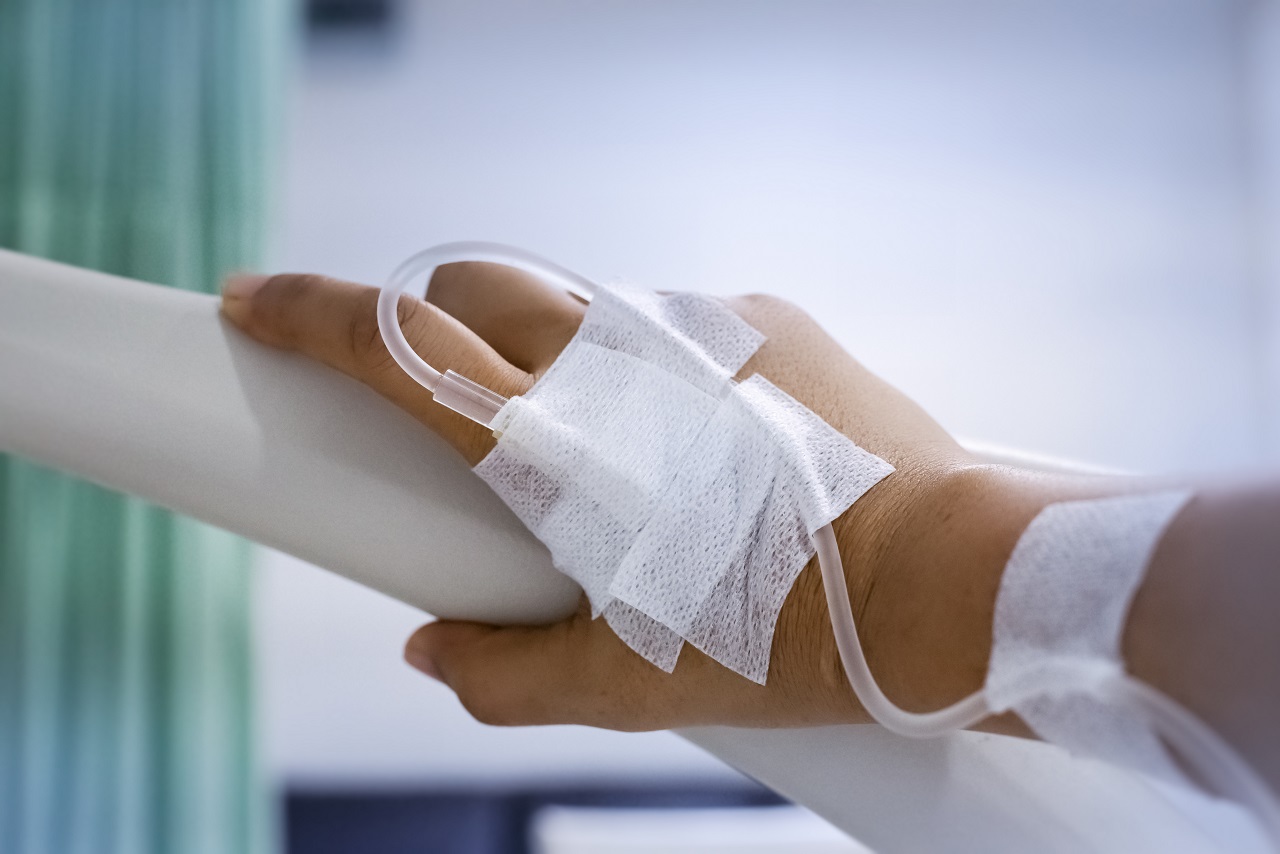 A hand with an IV getting chemotherapy