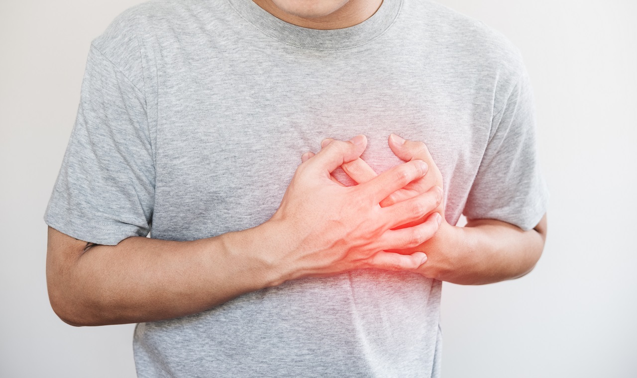 A man clutching his chest due to heart pain