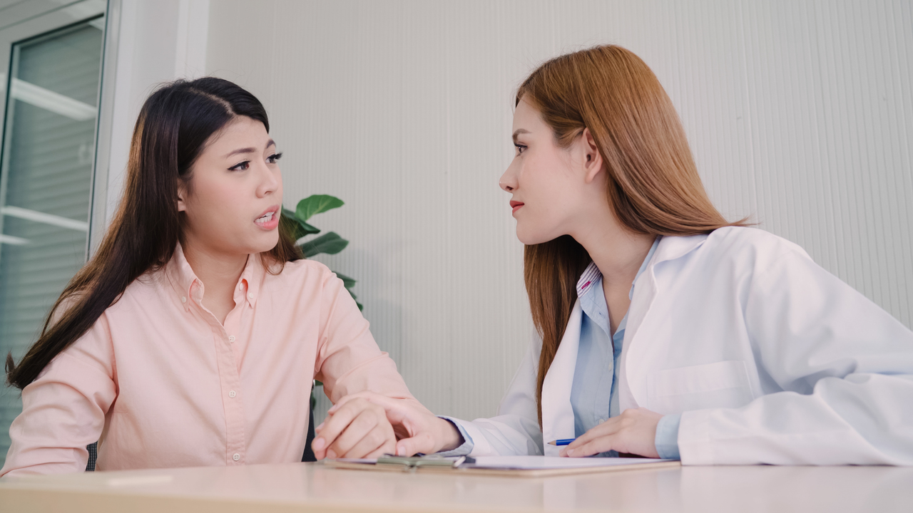 A gynecologist talking with a patient about a pap smear