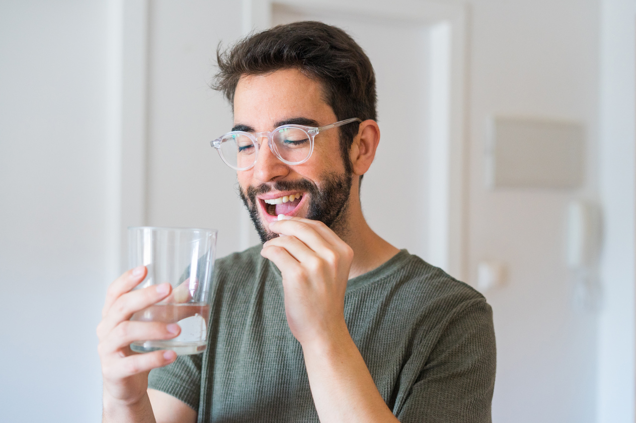 A man drinking oral medication