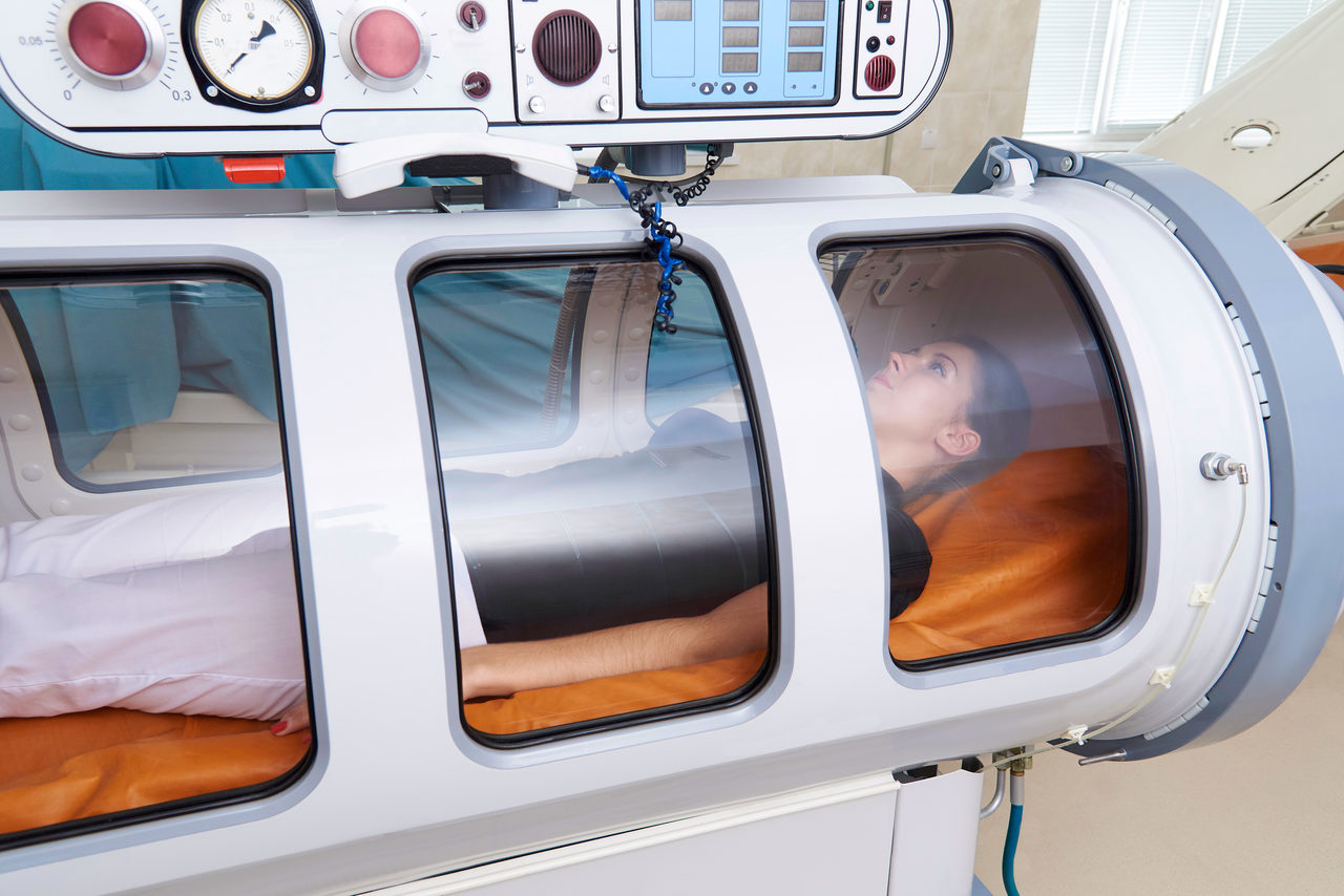 A woman inside a hyperbaric chamber